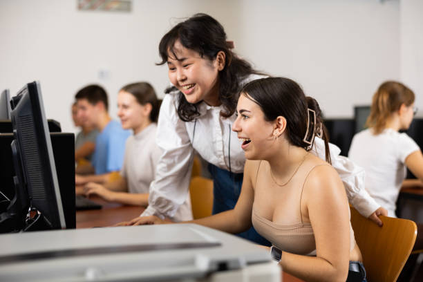 istock Teenage boys and girls using computers in IT class room 1485869678