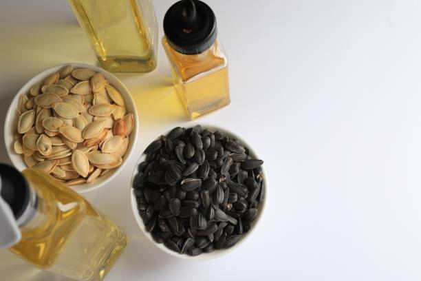 istock Bottles of different cooking oils and seeds on white background, above view 1485869891