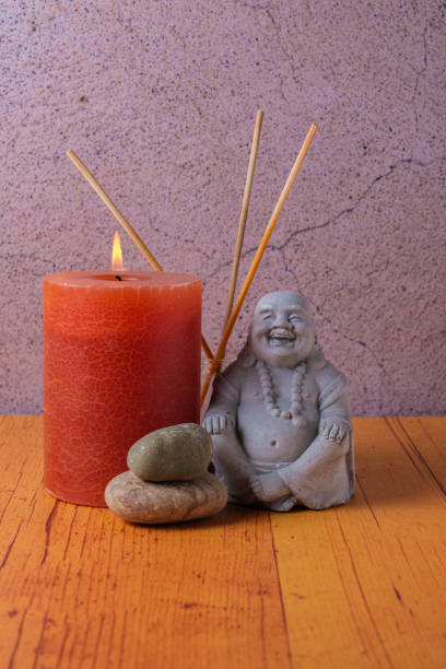 istock Buddha statue with candle and stones, meditation and relaxation 1485870468
