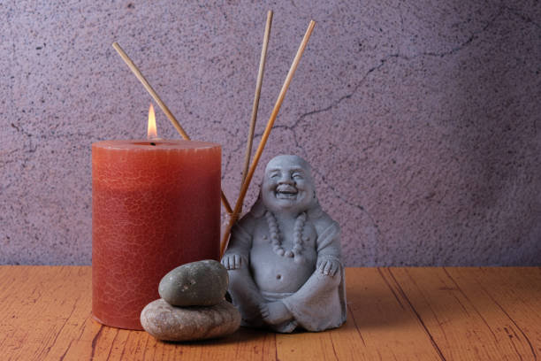 istock Buddha statue with candle and stones, meditation and relaxation 1485870472