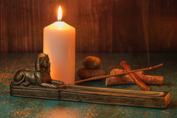 istock Sphinx incense holder, white candle, branches and stones 1485870473