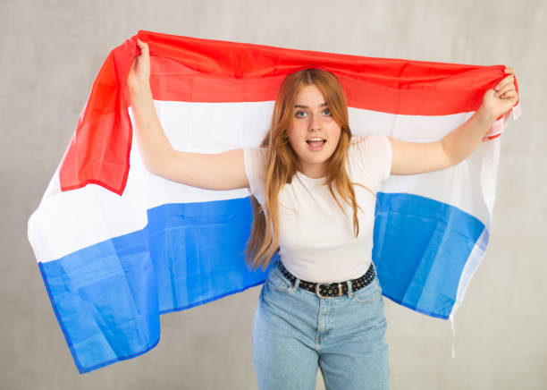 istock Attractive female student holding Netherlands flag 1485870660