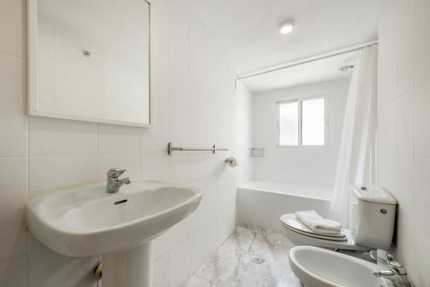istock Bathroom with shower cabin with curtain, white sink under mirror with fine white wood frame, stoneware floors 1485873157