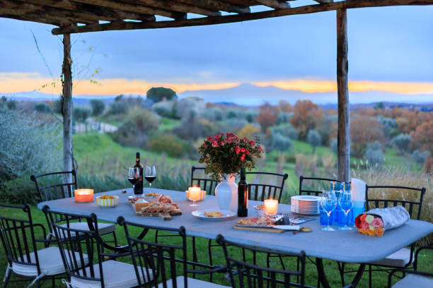 Romantic outdoor table, wine appetizer in Tuscany Outdoor table, wine appetizer in Tuscany golden hour wine stock pictures, royalty-free photos & images