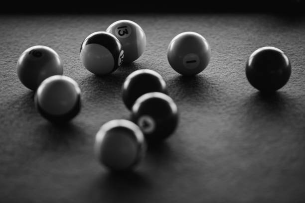 istock Nine pool balls on a fabric table, in a black and white photograph 1485887803
