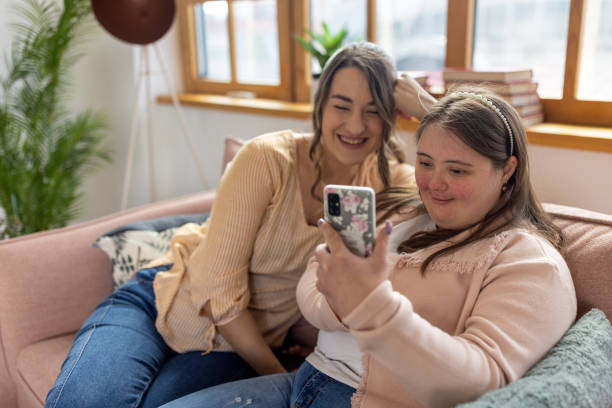 istock Female friends using phone together 1485890804