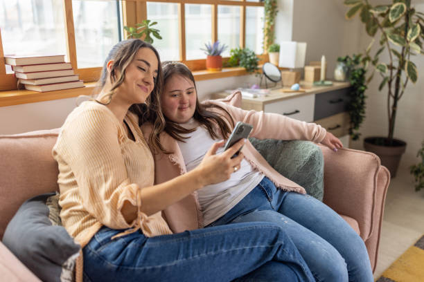 istock Female friends using phone together 1485891026