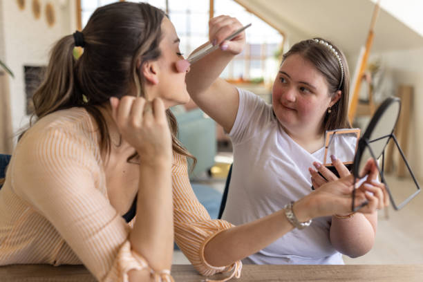 istock Woman putting make-up on her friend's face 1485893036