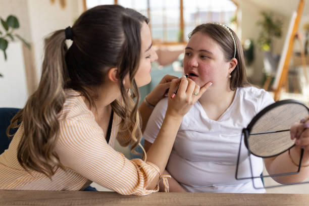 istock Woman putting make-up on her friend's lips 1485893161