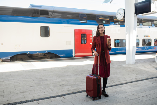 Beautiful Asian businesswoman on a journey arriving at the train station