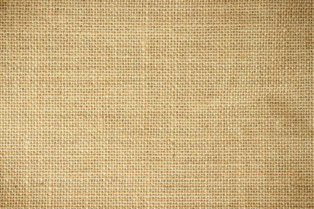 istock Jute hessian sackcloth burlap canvas woven texture background pattern in light beige cream brown color blank. Natural weaving fiber linen and cotton cloth texture as clean empty for decoration. 1485897597