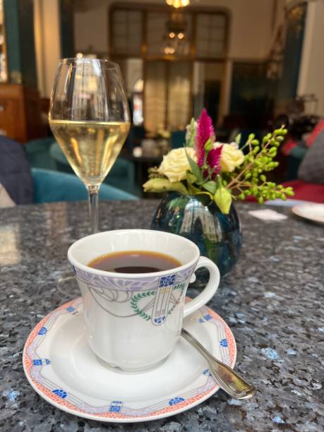 istock a cup of coffee and wine glass on the table 1485905398