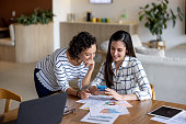 Coworkers working together on a social media strategy at the office