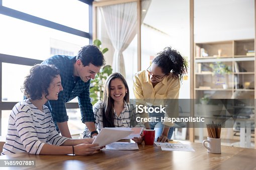 istock Happy group of workers sharing ideas in a business meeting 1485907881