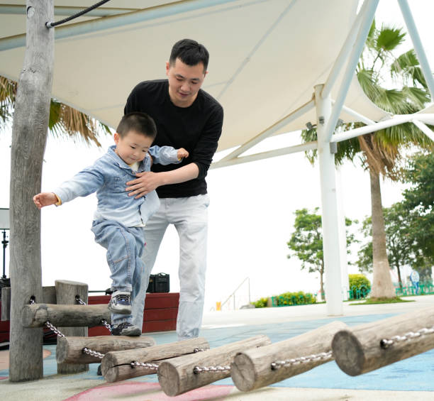 istock The father helped his son across the single-log bridge 1485920891