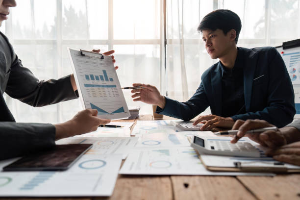 istock business team discussion of reports displayed in charts and graphs. analyze financial statistics brainstorming business team people review analyze financial reports 1485925704