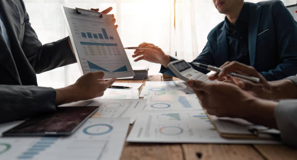 istock Business team presents and explains and using tablet discuss marketing numerical charts that display financial budgets, investments, project plans 1485925763