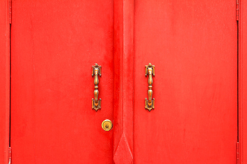 light and shadow on the red door,old red door with a retro-style handle,