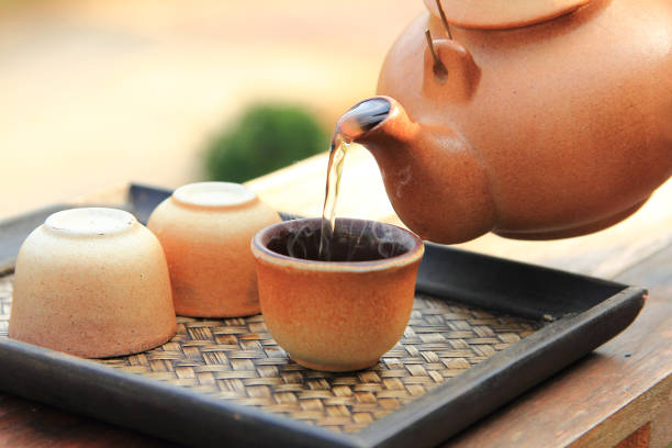istock close up earthenware teapot with pouring hot tea in a brown cup are placed on the table for healthy drinking in morning time 1485929405