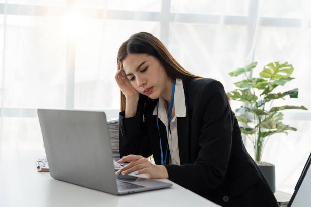 istock Businesswoman are stressed while working on laptop tired with headache at office, feeling sick at work 1485931009