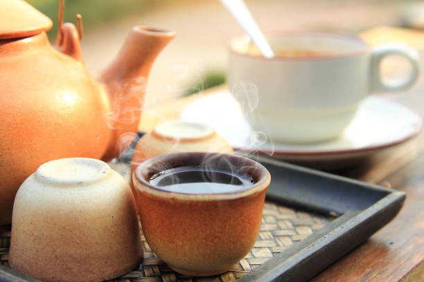 istock close up earthenware teapot with pouring hot tea in a brown cup are placed on the table for healthy drinking in morning time 1485931118