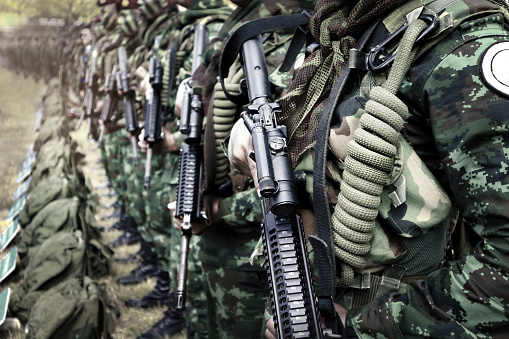 Thai soldiers stand in row.commando soldiers in camouflage uniforms gun in hand,close up of army and preparation for battle.