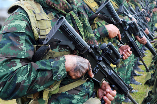 Thai soldiers stand in row.commando soldiers in camouflage uniforms gun in hand,close up of army and preparation for battle