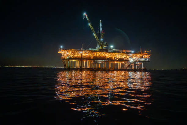 istock Night-time aerial view showcases the Esther platform, an offshore fracking drill rig located in the Pacific Ocean near Los Angeles, illuminating the dark waters. 1485934447