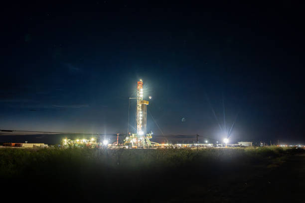 istock Drilling rig platform in New Mexico illuminates the sky as it performs fracking operations to extract oil from the earth 1485934508