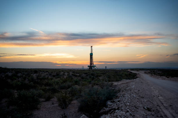 istock As the sun sets, an oil drilling platform and rig silhouette against the orange sky, while performing fracking to extract oil from beneath the earth's surface 1485934683