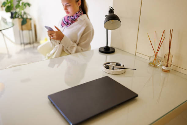 istock Beautiful young woman texting on mobile mobile in home office 1485936776