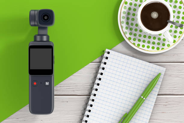 istock Pocket Handheld Gimbal Action Camera, Blank Note Pad with Pen and Cup of Coffee. 3d Rendering 1485938302