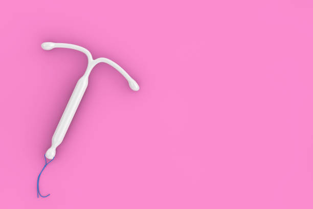 Birth Control Concept. T Shape IUD Hormonal Intrauterine Device. 3d Rendering Birth Control Concept. T Shape IUD Hormonal Intrauterine Device on a pink background. 3d Rendering iud stock pictures, royalty-free photos & images