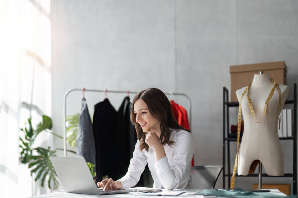 istock Responding on business e-mail. Beautiful young Fashion designer woman working using computer and smiling while siting in home 1485941167