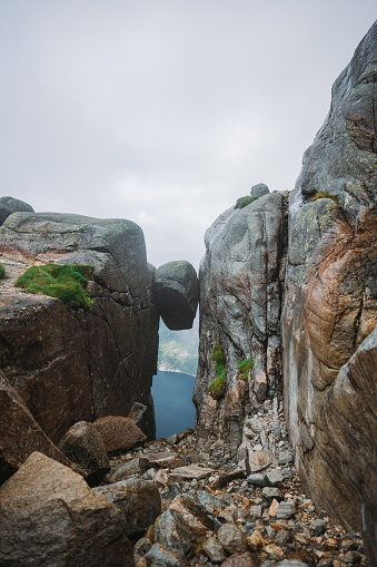 Dramatic landscape of Kjeragbolten  rock stuck on the background of fjord in Norway