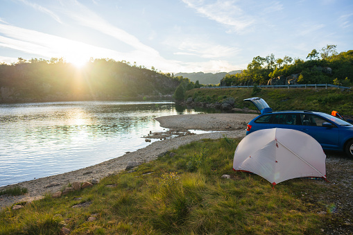 Scenic view of tent and car near the lake in Norway
