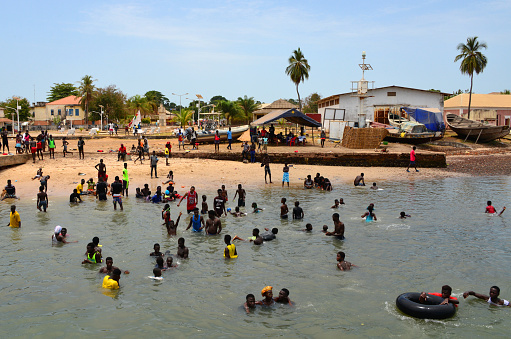 Cacheu, Guinea-Bissau: people enjoying the beach in front of the main square - banks of the Cacheu River, already in an estuarine region with the Atlantic Ocean.