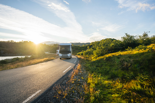 Camper van on road at sunset in Norway