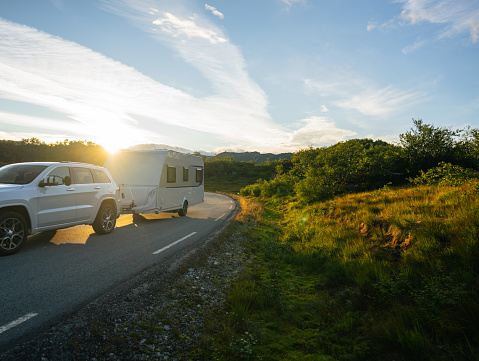 Camper van on road at sunset in Norway