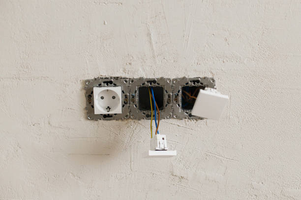 istock Electric box with socket and switch. Installing electricity connector in plastered wall. Construction of house and home renovation concept. Cabling 1485959175