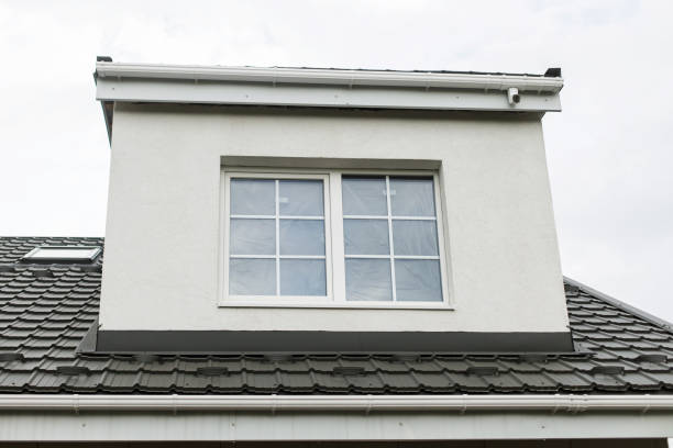 Stylish building with unfinished facade, white windows, modern black roof and dormer. Modern new farmhouse building exterior. Stylish building with unfinished facade, white windows, modern black roof and dormer. Modern new farmhouse building exterior. dormer stock pictures, royalty-free photos & images