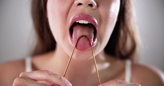Tongue Cleaner Brush Or Scraper. Woman Scraping