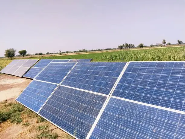 Solar panels installed in agriculture field under sun for irrigation tube well on solarenergy paneles solares, panneaux solaires, paineis solares, view image picture stock photo.