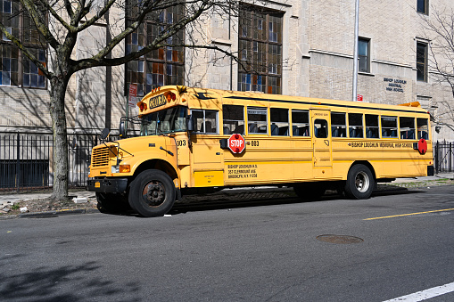 New York City, United States, April 8, 2023 - Bishop Loughlin Memorial High School school bus in Brooklyn, New York.