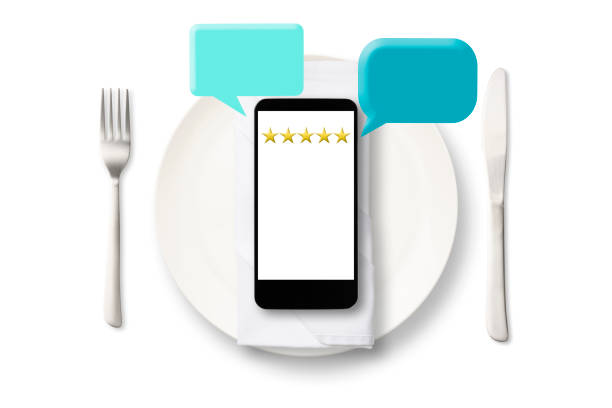 Close-up of smartphone with reviews evaluation on five star rating on a white plate on white background.\nCustomer feedback concept