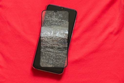 mobile phone and broken tempered glass on an isolated background, glass replacement