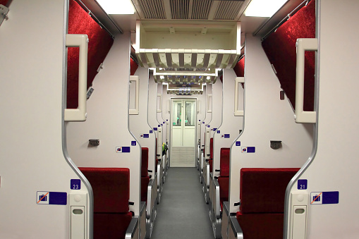 first class train travel,red velvet chair, interior view of a modern high speed train,interior of a public transport vehicle.