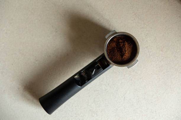 istock Top view of metal holder with plastic handle from the coffee machine with ground coffee inside. 1485971477