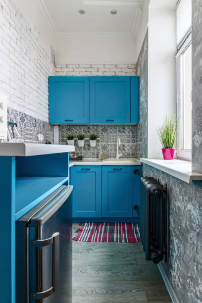 istock Very small kitchen with blue cabinets and window 1485972296