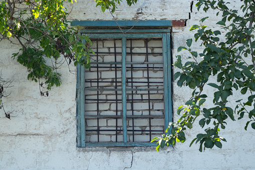 bricked window and grate in an abandoned house